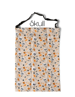 White candy bag with gray skulls and orange pumpkin confetti pattern.