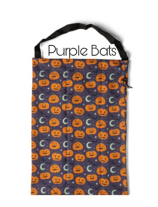 Dark purple candy bag with orange jack-o'-lanterns and crescent moon pattern.
