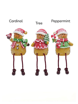 Three sitting resin shelf sitters in cardinal, tree, and peppermint designs, long legs