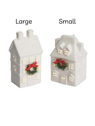 Large and small white ceramic LED house decorations with lit windows, wreath and red bow