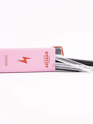 Stitchy refill pack with pink casing, orange lightning mark, and black-and-white refill strips