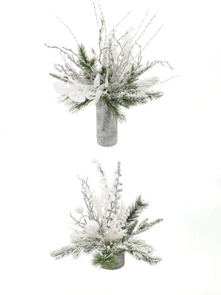 Two snowy pine decor arrangements with frosted branches and gray bases