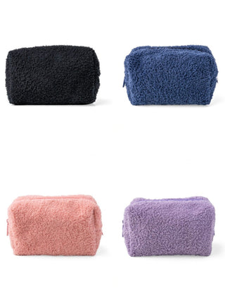 Set of four fuzzy travel toiletry bags: black, navy, pink, and purple