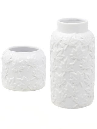 Set of two white ceramic jars with embossed floral pattern, different heights