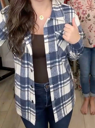 Long sleeve plaid jacket in blue and white with button front, close-up