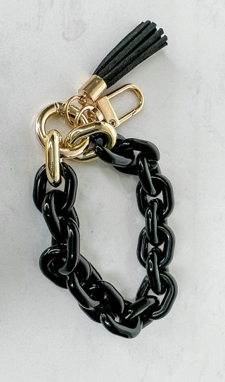 Keychain with black chain links, gold D-ring clasp and hanging tassel