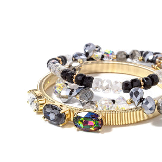 Gold-tone cuff bracelet stack with black, clear, and iridescent crystal beads