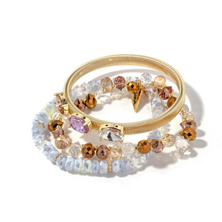 Gold-tone beaded bracelet stack with clear stones and warm amber/gold accents