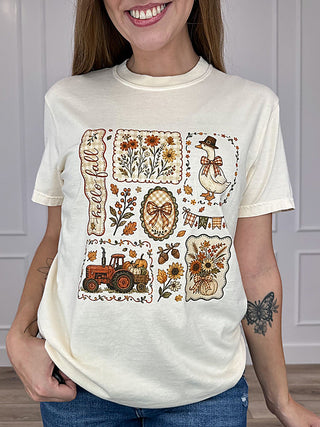 Cream short-sleeve cotton graphic tee with fall patchwork illustration on front