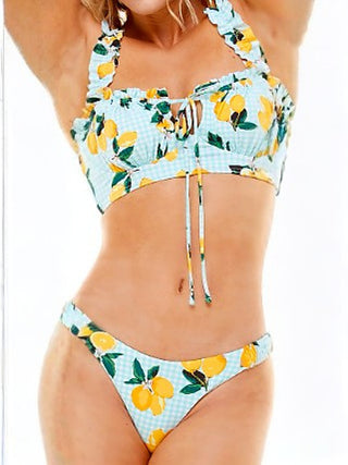 Two-piece swim set with lemon print ruffled top and matching bikini bottoms, light blue.