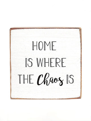 Wood block sign with "Home is where the Chaos's" handwritten black text