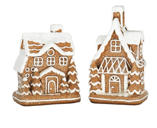 Two gingerbread-style resin houses with white icing and brown facade details