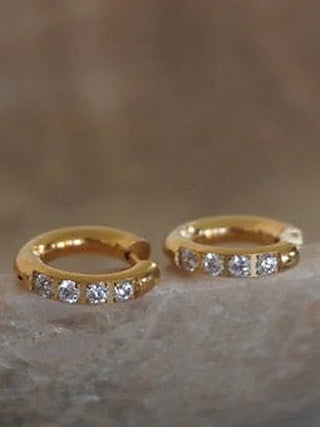 Gold-tone huggie earrings with crystal-studded row, shown as a pair