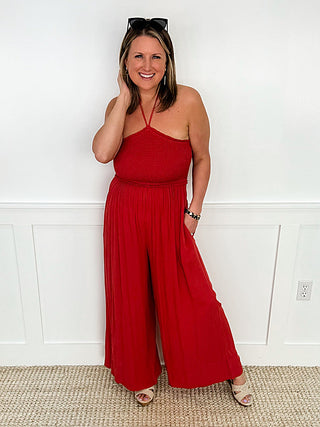 Red rayon halter jumpsuit with spaghetti straps and wide-leg silhouette