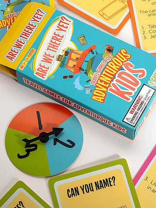 Travel game set box with airplane spinner and cards, colorful adventure design