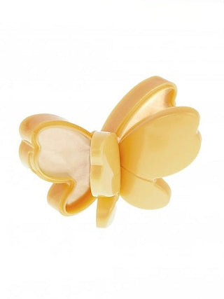 Butterfly-shaped lip balm in gold with white center