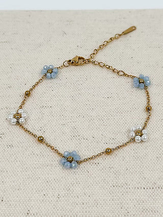 Gold bracelet with blue flower charms and pearl beads, toggle clasp