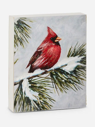 Cardinal wood block sign with red bird facing right on snowy pine bough