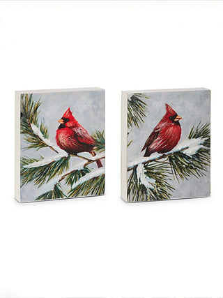 Cardinal wood block sign with red bird perched on snowy pine branches
