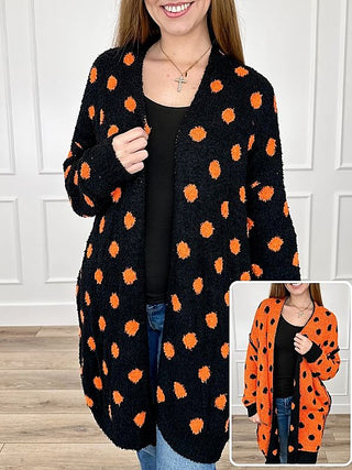 Reversible knit cardigan with orange dot pattern on black, long sleeves, open front