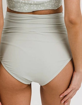 High-rise light-gray swim bottoms with ruched waistband and V-shaped front seam