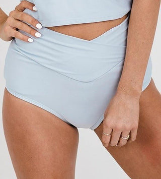 High-rise light-blue swim bottoms with ruched waistband and V-shaped front seam