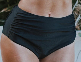 High-rise swim bottom in black with ruched waist and moderate coverage