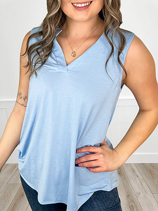 Light blue sleeveless V-neck tank top with draped front hem