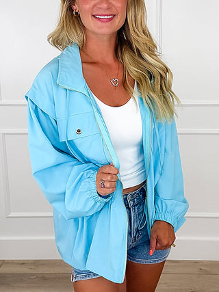 Lightweight blue hooded long-sleeve jacket with front snap buttons and chest pocket