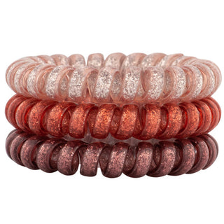 Rose pink hair coil set with glitter sparkle, stacked glossy mini coils.