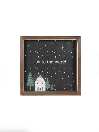 Wood joy-to-the-world sign with sparkles, cross-like star, trees, and framed brown border