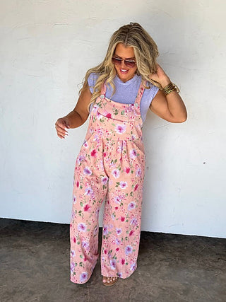 Pink floral ribbed overalls with adjustable straps and wide legs