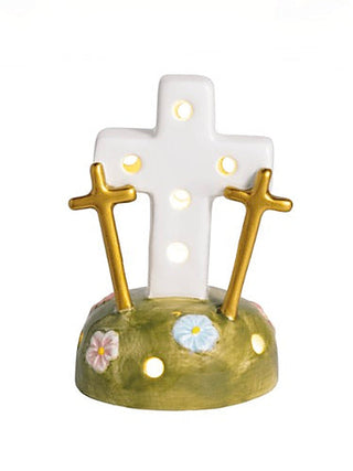 Ceramic light-up shelf sitter with green base and three gold crosses glowing white
