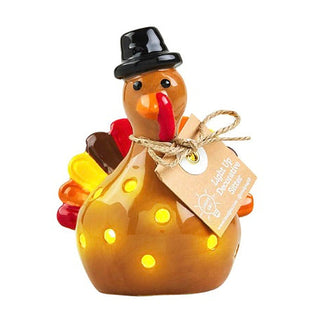 Ceramic light-up shelf sitter of a snowman in black top hat with red scarf