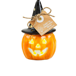 Ceramic light-up jack-o’-lantern shelf sitter with black witch hat lid