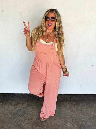 Coral ribbed sleeveless overalls with adjustable straps and front pocket