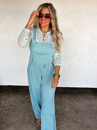 Light blue ribbed sleeveless overalls with adjustable straps and front pocket