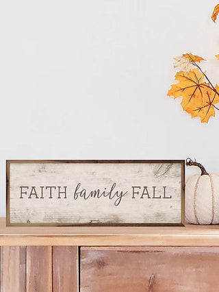 Wood shelf sitter with 'FAITH family FALL' lettering and small white pumpkin