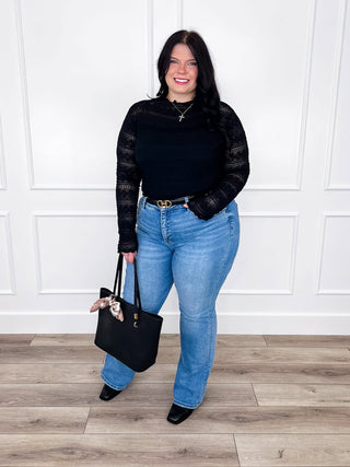 Black sheer lace long sleeve top paired with light wash straight leg jeans and black booties.