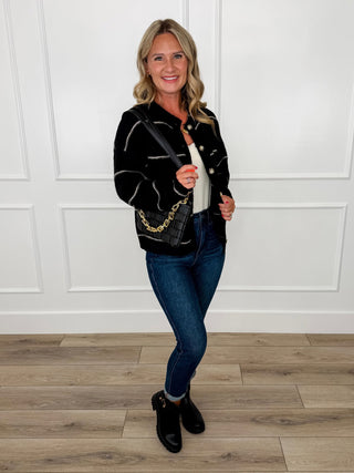 Black contrast-stitch cardigan with blue jeans and black ankle boots