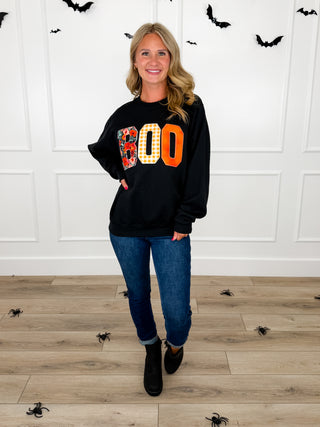 Model wears a black Boo applique graphic sweatshirt with Judy Blue Kyla jeans and black booties.