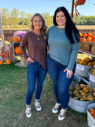 Brown and teal waffle knit tops with blue jeans and sneakers, women outfit