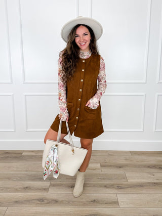 Brown faux suede button up dress layered over an ivory floral mesh top with a cream panama hat.