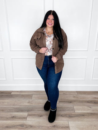 Camo print tank layered under a brown shacket with Judy Blue Kyla skinny jeans and black booties.