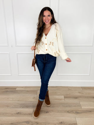 Cream bow-embroidered cardigan with dark blue jeans, full outfit view