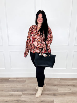 Two-piece outfit: long-sleeve floral blouse with black pants and black tote bag