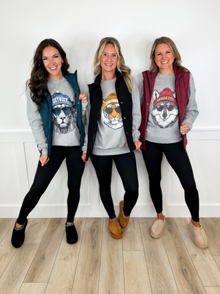Grey Game Day city graphic crewneck sweatshirts styled with puffer vests, black leggings, and slip-on shoes.