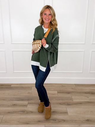 Olive green oversized weekender top with Judy Blue Kyla dark wash skinny jeans and tan clogs.
