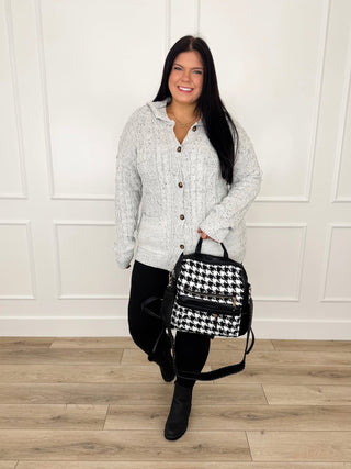 Grey speckled cable knit cardigan with black leggings, front buttoned