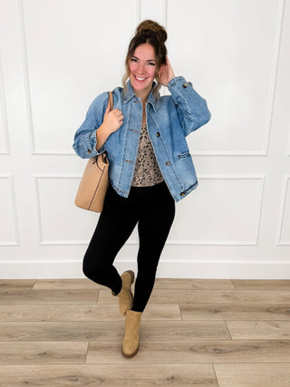 Cropped medium-wash denim jacket with floral lace tank and black leggings